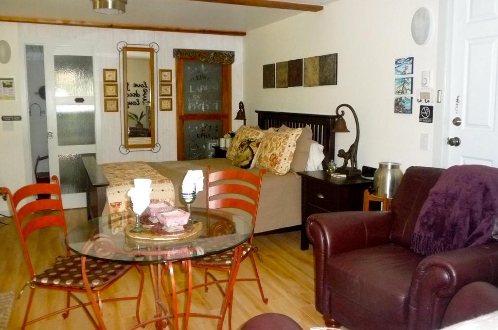 a living room with a glass table and a couch at Magnolia Petal in Ganges