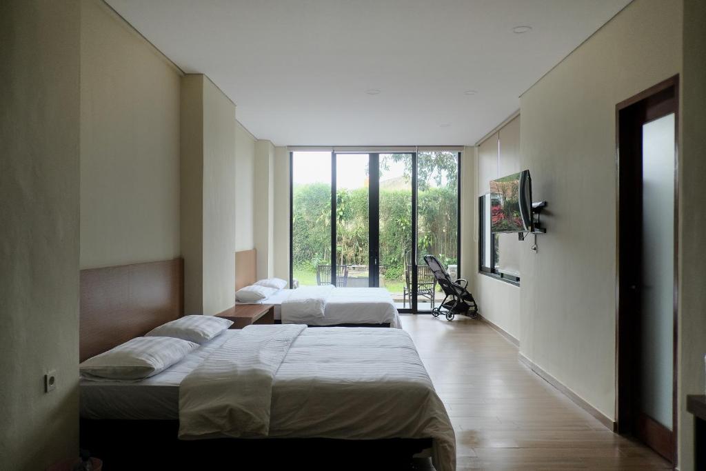 Postel nebo postele na pokoji v ubytování Balconé Bandung