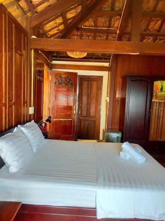 Postel nebo postele na pokoji v ubytování Cham Island Wooden Cabin