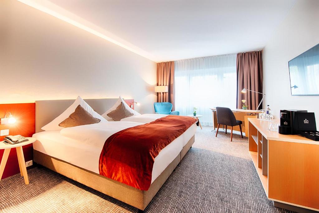 Postel nebo postele na pokoji v ubytování Welcome Hotel Marburg