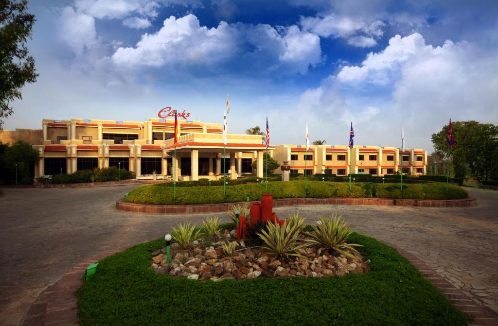 a large yellow building with flags in front of it at Clarks Khajuraho in Khajurāho