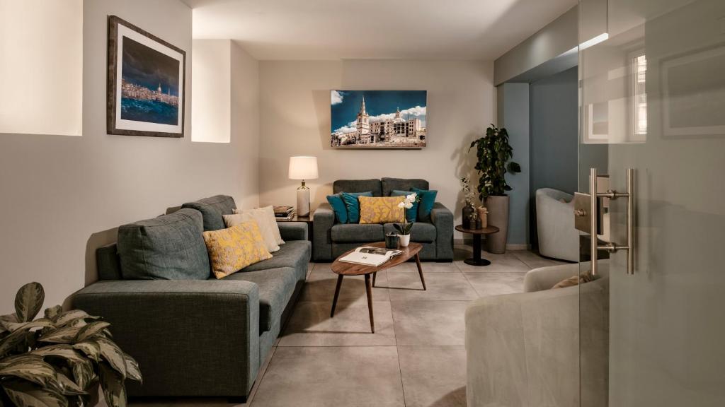 a living room with a couch and a table at The Howard Hotel in Sliema