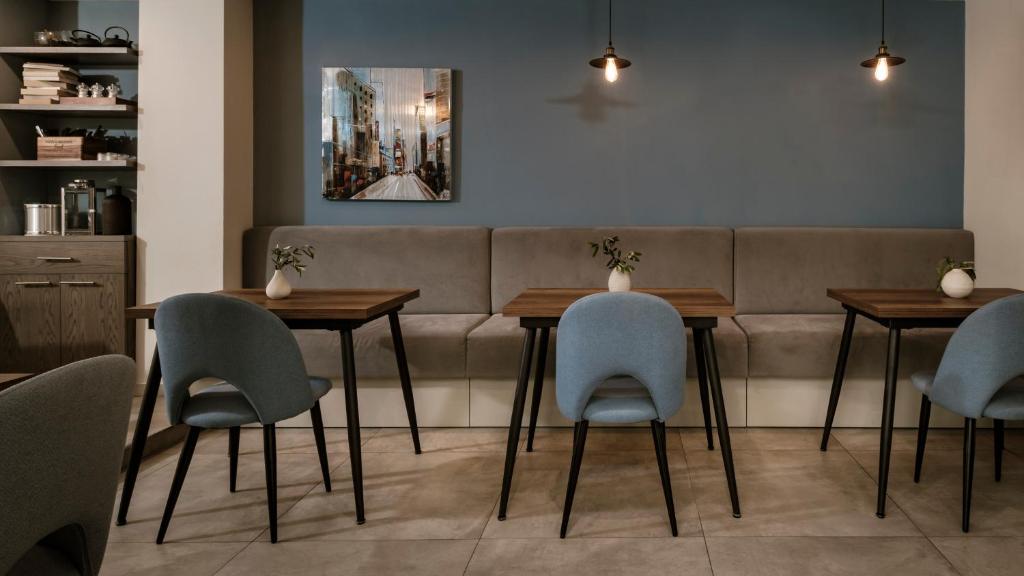 a restaurant with tables and chairs and a couch at The Howard Hotel in Sliema