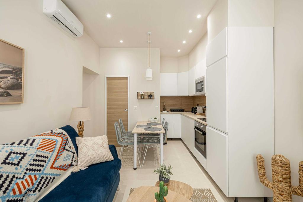 un salon avec un canapé bleu et une cuisine dans l'établissement Cozy renovated apartment - 1BR4p - Hyper Center, à Antibes