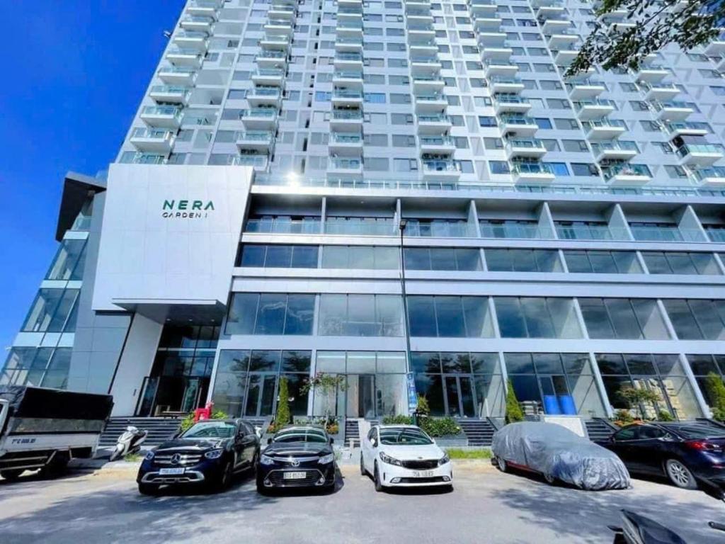 a large building with cars parked in front of it at JULY Homestay Nera huế in Thôn Văn Dương