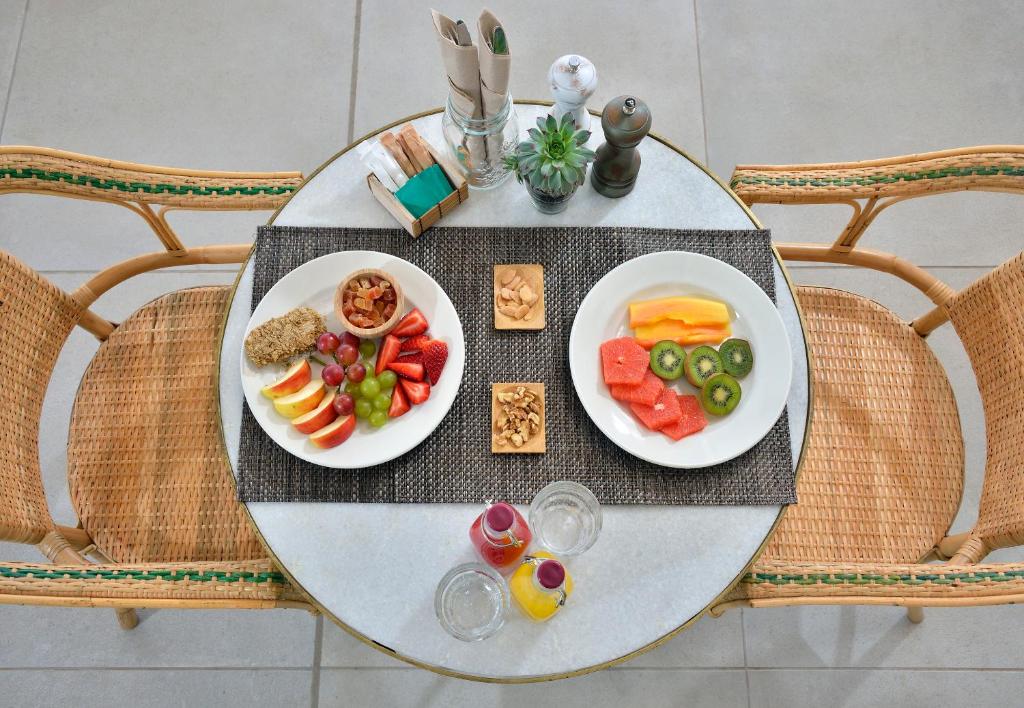 a table with two plates of food on it at INNSiDE by Meliá Fuerteventura – Adults Only in Costa Calma