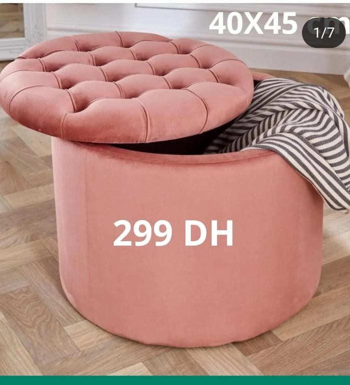 a red ottoman with a pinkinyl dog bed at Appartement raha in Meknès