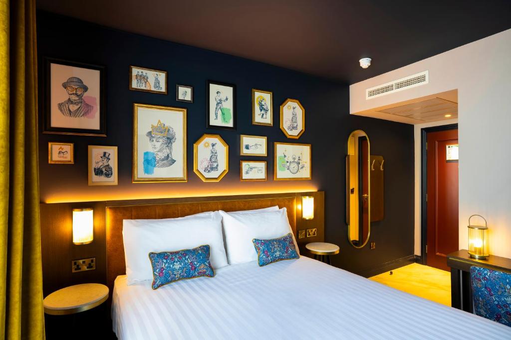 a bedroom with a bed and some pictures on the wall at The Mercantile Hotel in Dublin