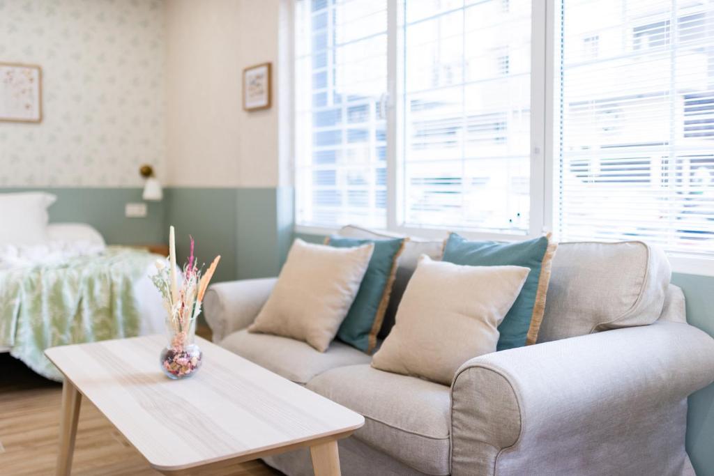 een woonkamer met een bank en een tafel bij Estudio reformado en Granada in Granada