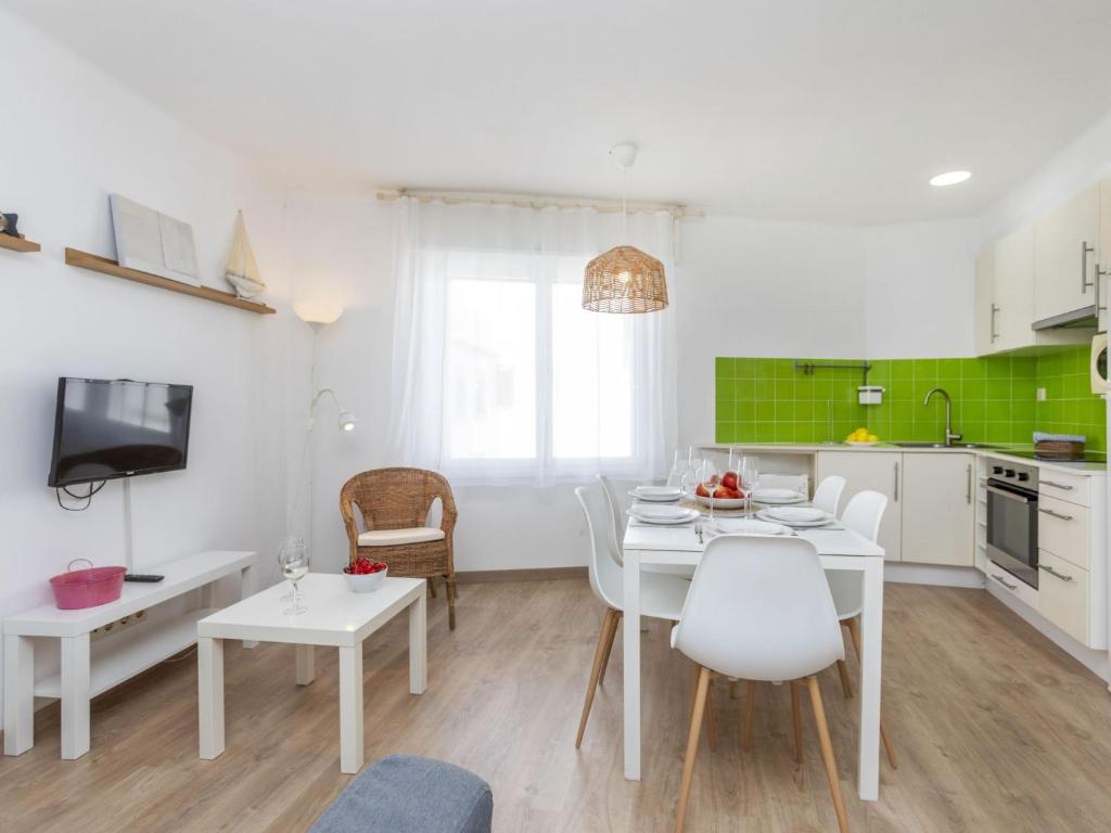 a kitchen and dining room with a white table and chairs at Apartment Marinada by Interhome in Tossa de Mar