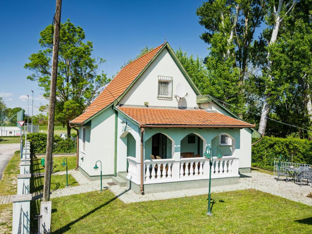 a small white house with an orange roof at Holiday Home Green House by Interhome in Balatonmáriafürdő