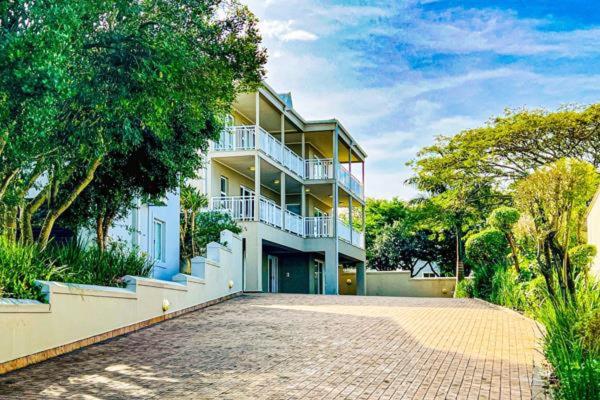 a large white building with a driveway in front of it at Princes Grant 2 Bedroom Apartment in Blythedale