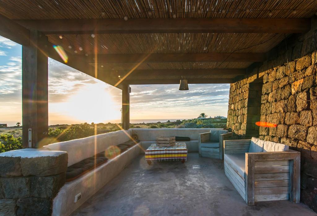 a patio with a couch and a table at Dammuso Ma.Vi in Pantelleria