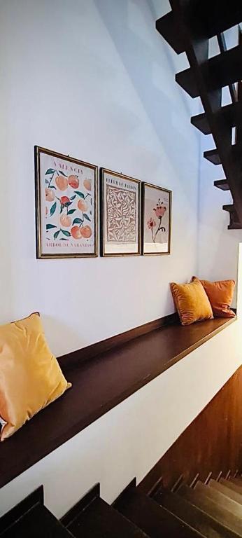 three pillows sitting on top of a wooden bench at Casa Costa in Lipari