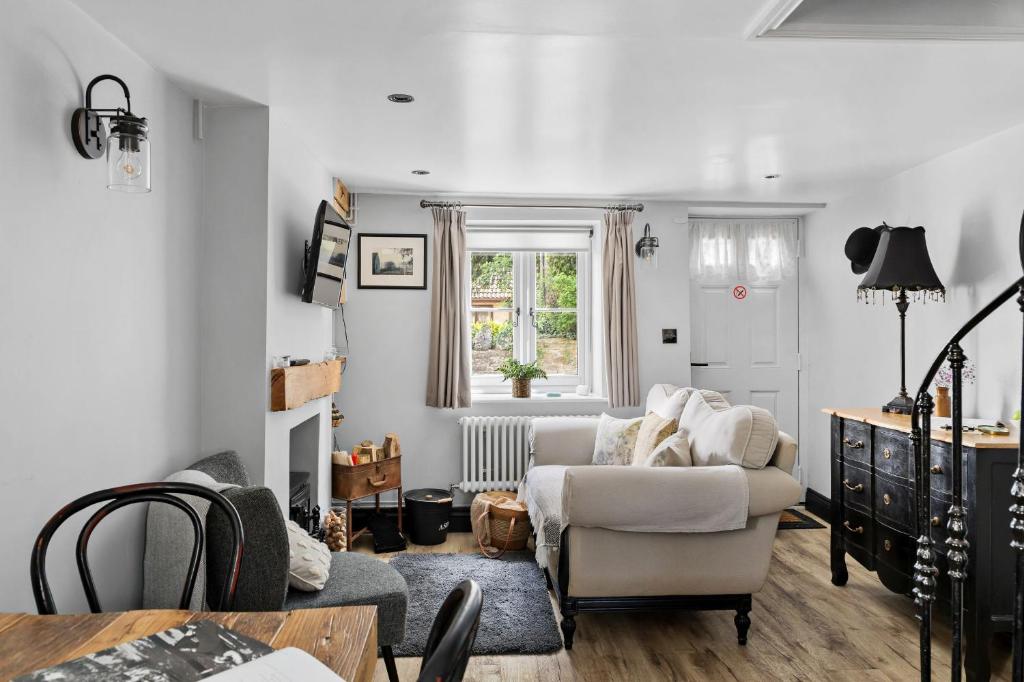 a living room with a couch and a chair at Apothecary Cottage - Pet Friendly Wedmore Couples Cottage - Free WiFi - Free Parking in Wedmore
