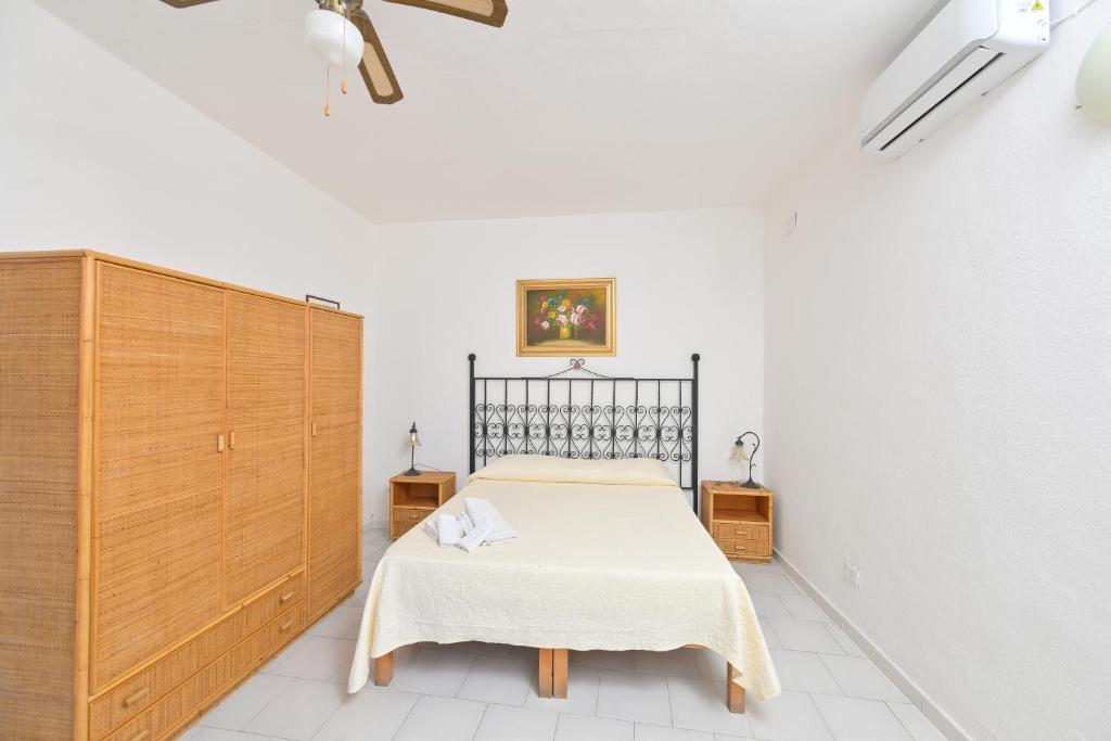 Postel nebo postele na pokoji v ubytování Resort Punto Azzurro