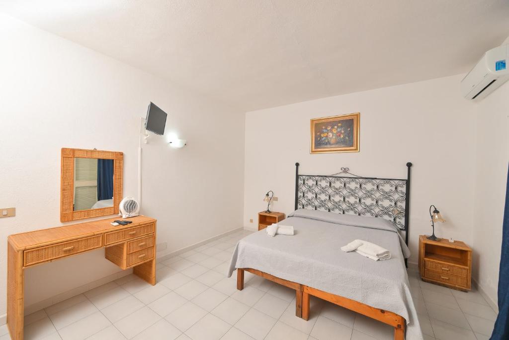Postel nebo postele na pokoji v ubytování Resort Punto Azzurro