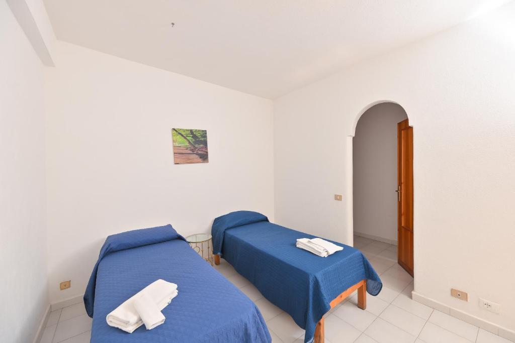 Postel nebo postele na pokoji v ubytování Resort Punto Azzurro