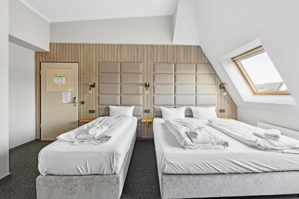 Postel nebo postele na pokoji v ubytování Hotel Comenius