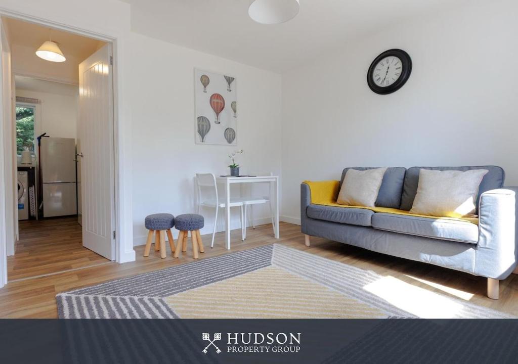 a living room with a couch and a table at 1-Bedroom Apartment with Parking in Wellington