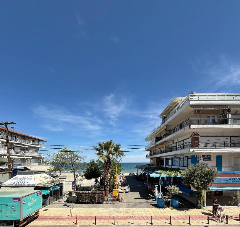 a building on the beach with the ocean in the background at SkyView Paralia in Paralia Katerinis