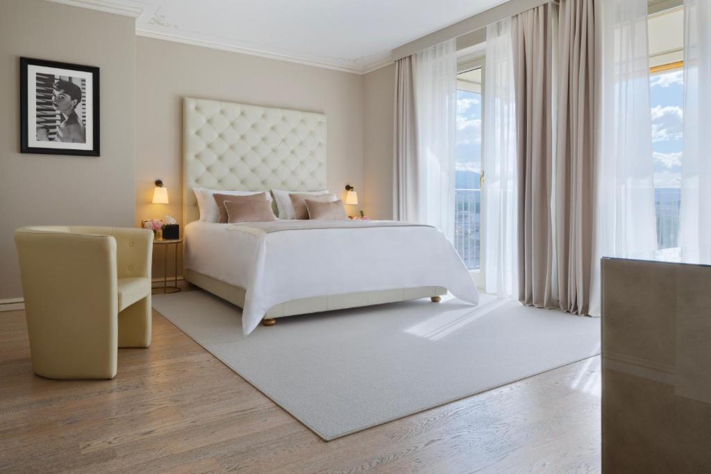 a bedroom with a white bed and a large window at Grand Hotel Imperiale in Forte dei Marmi