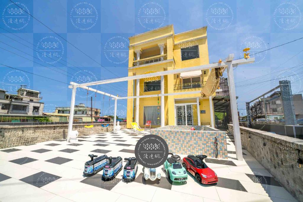 a group of toy cars sitting on a checkered floor at We Kids B&B in Wujie