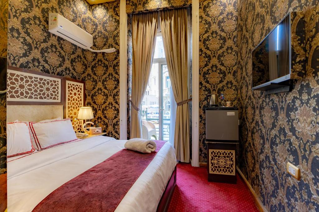 Postel nebo postele na pokoji v ubytování Cairo Inn