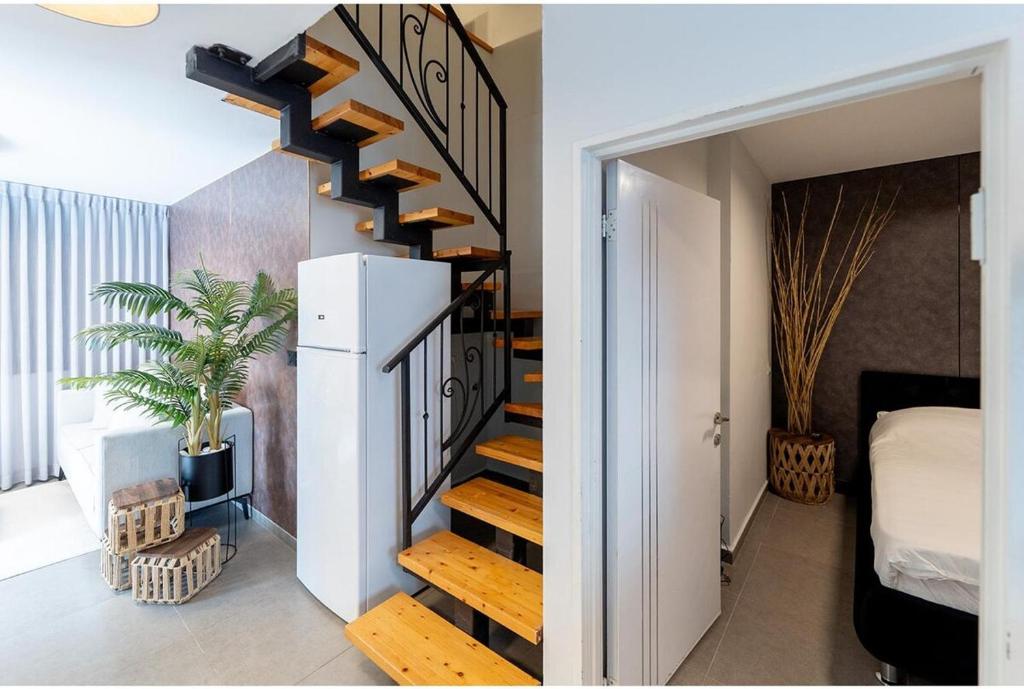 a spiral staircase in a room with a bedroom at URBAN Modern accommodation in the Galilee in Qiryat Shemona