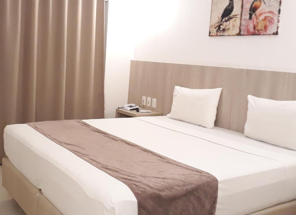 Postel nebo postele na pokoji v ubytování Pena Branca Hotel e Eventos