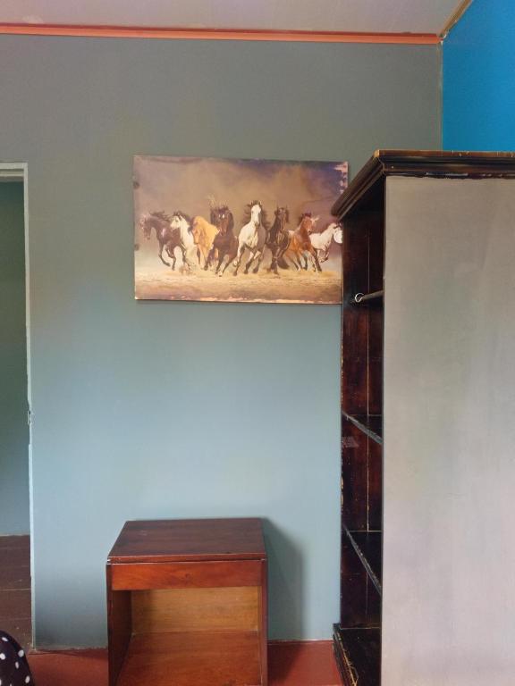 a painting of horses running on a wall at Hostal Vista Boquete in Bajo Boquete