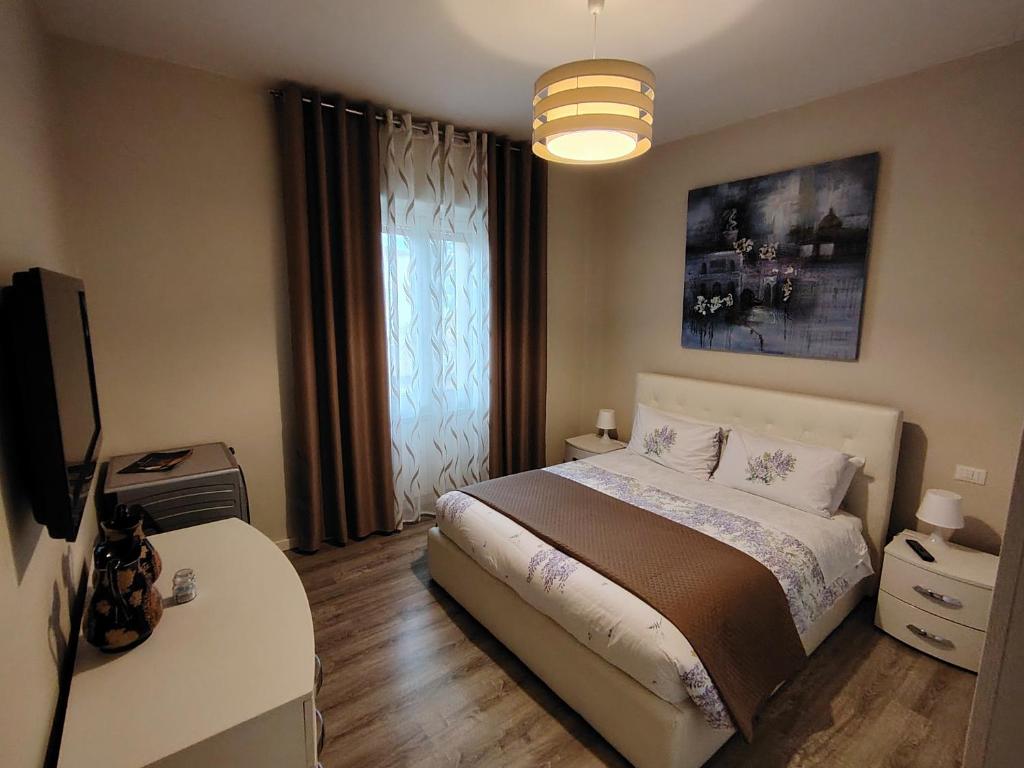 a bedroom with a bed and a television in it at Appartamento Maggi in Brescia