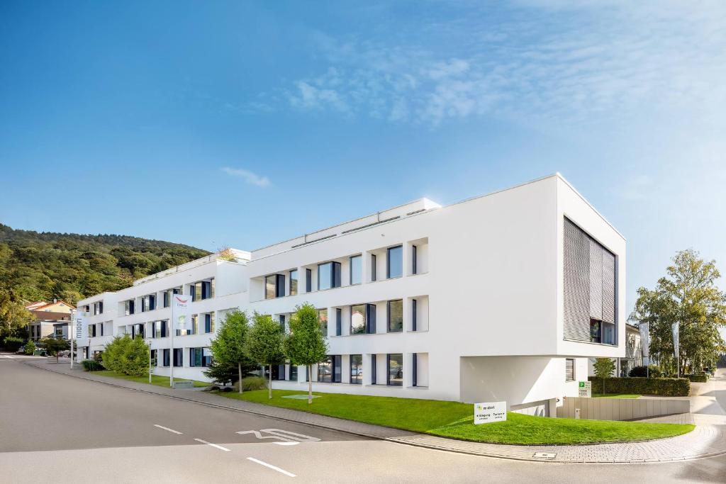 a rendering of a white building on a street at Midori - The Green Guesthouse in Dossenheim