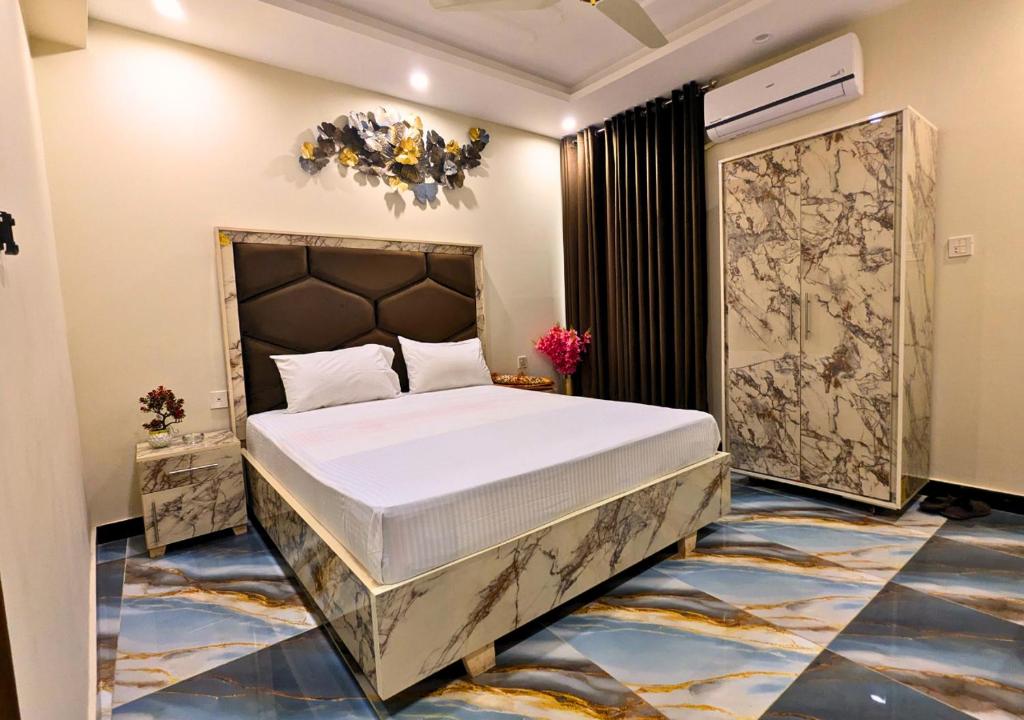a bedroom with a large bed in a room at Blue Sky Hotel in Lahore