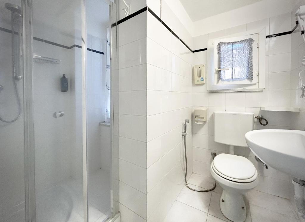 a bathroom with a shower and a toilet and a sink at Hotel Meublè Agavi in Monterosso al Mare