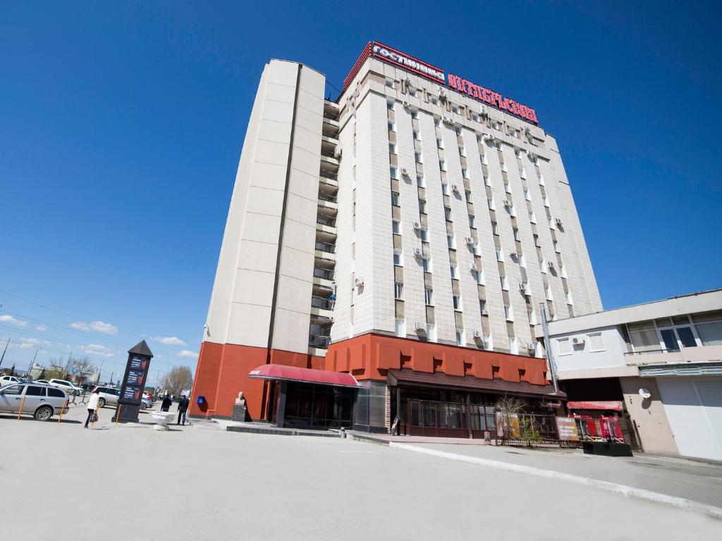 a large white building on the corner of a street at Oktyabrskaya Hotel in Samara