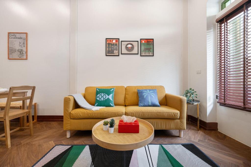 un soggiorno con un divano e un tavolo di Moondance House Chinatown a Bangkok