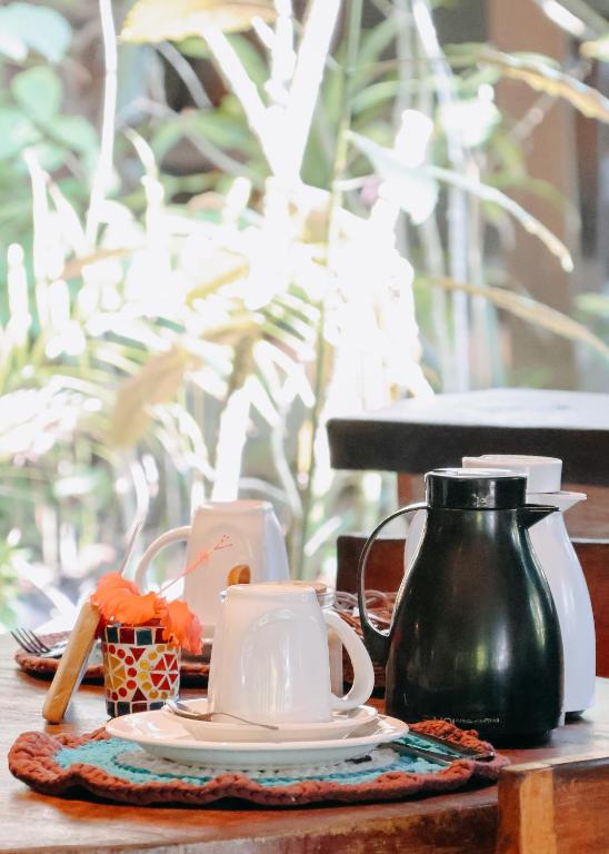 a table with a plate and a tea pot on it at Na Villa dos Algodões in Marau