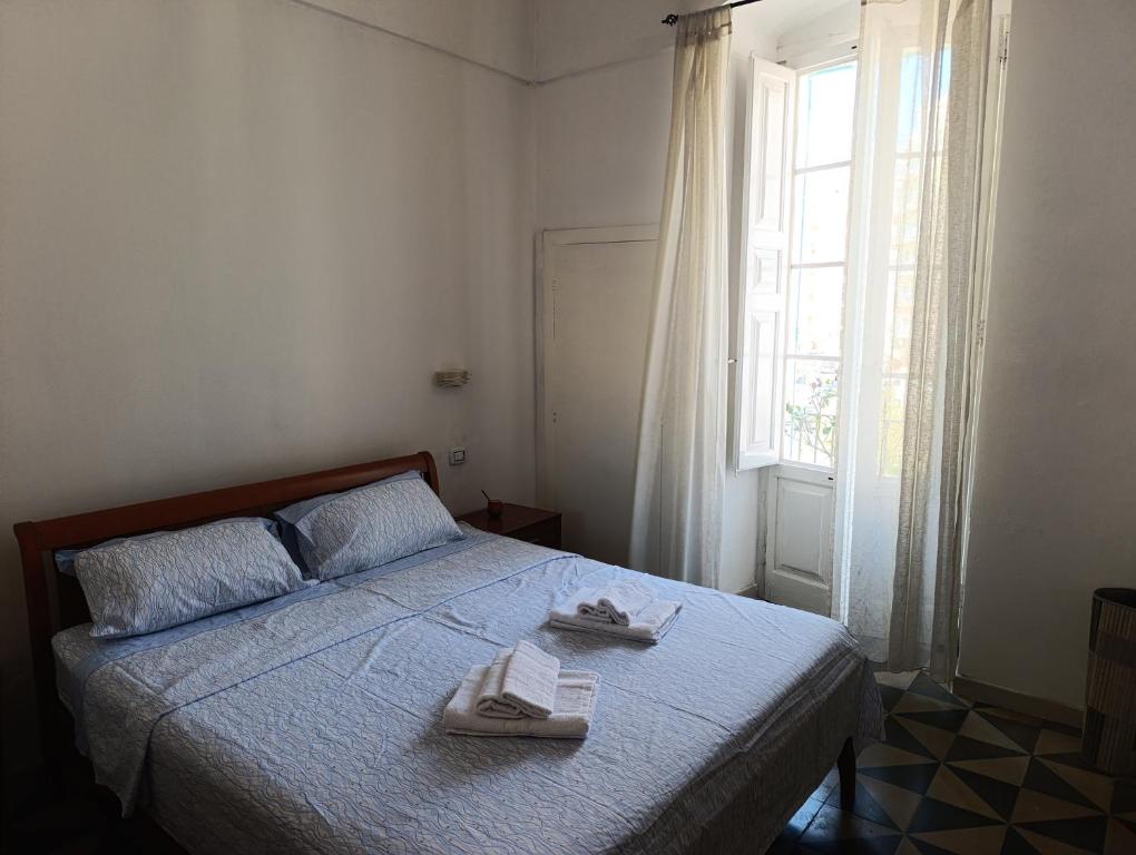 a bedroom with a bed with two towels on it at Sweet House Monopoli in Monopoli