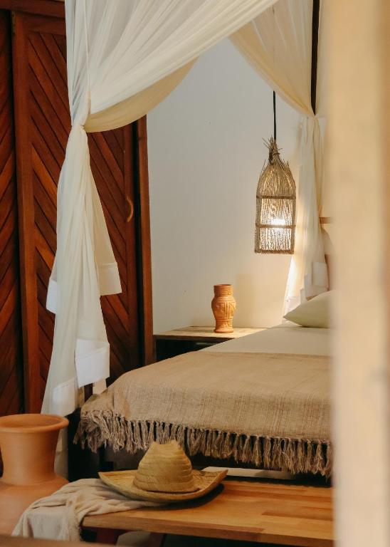 a bedroom with a bed with a canopy at Na Villa dos Algodões in Marau
