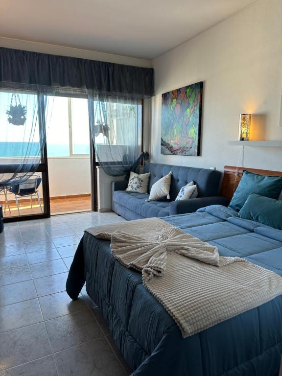 a living room with a bed and a couch at Estúdio Azul-T0-Torralta-Ocean View by Aura in Alvor
