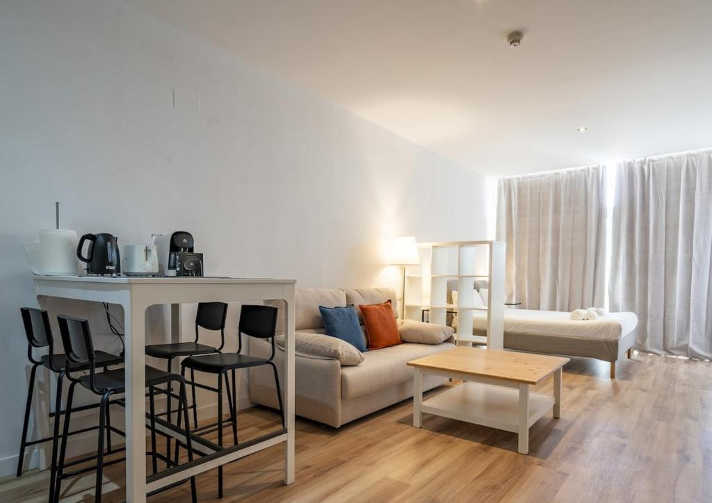 a living room with a couch and a table at The Urban Studio Madrid in Madrid