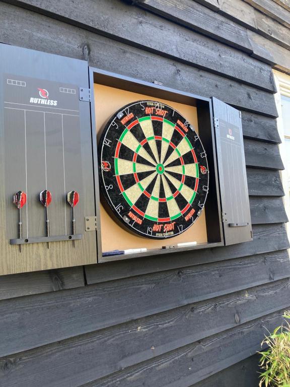 a dart board on the side of a house at Lime Tree Cottage in Tillingham