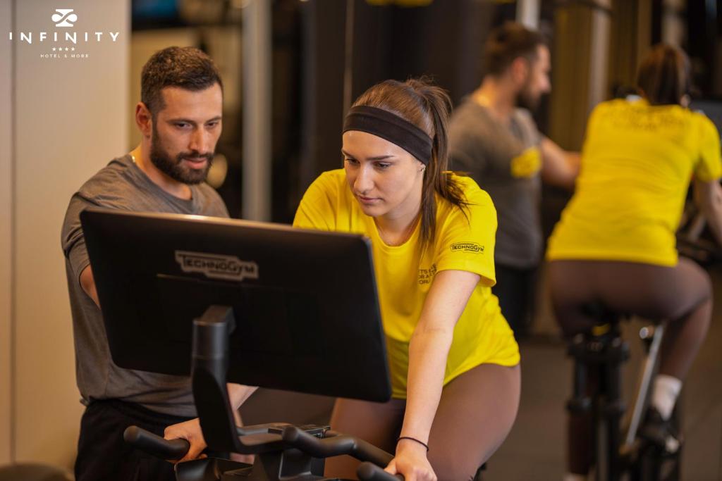 a woman working on a laptop on a bike at Infinity Hotel & More in Budva