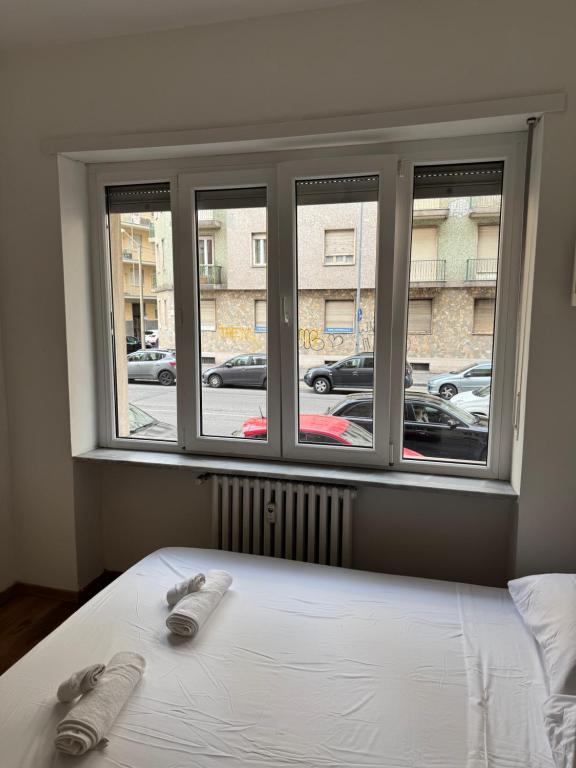 a bedroom with a window with two slippers on a bed at Gorizia Living in Turin
