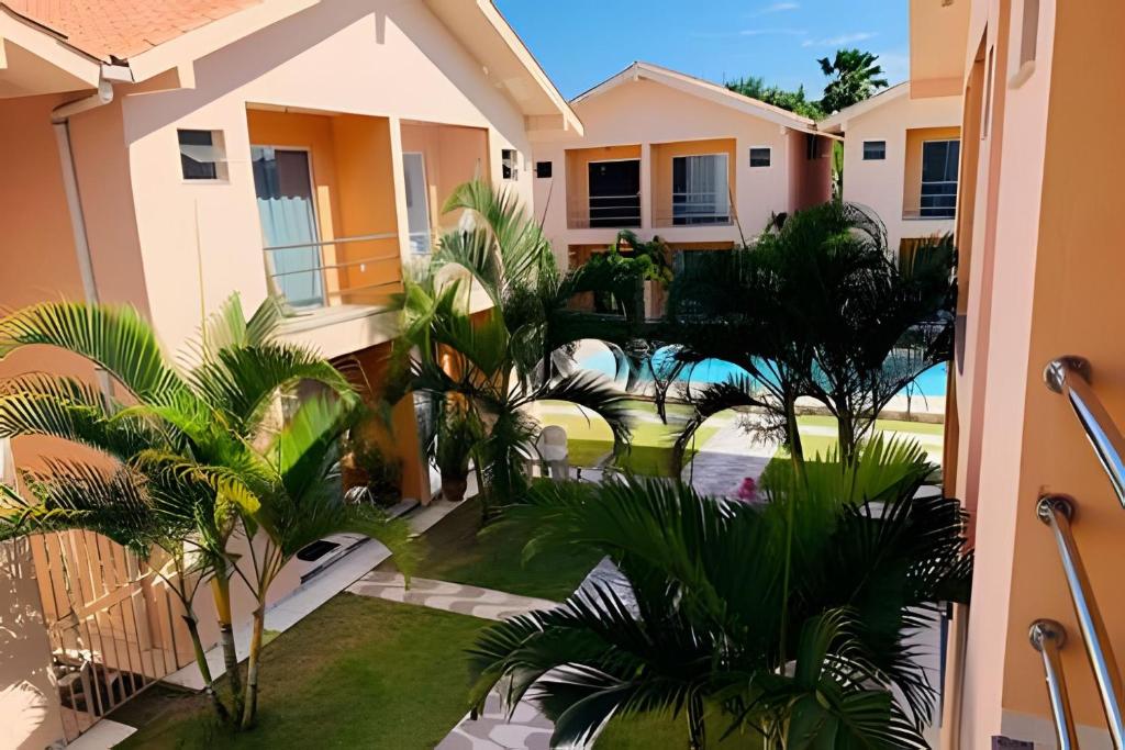 a view from the balcony of a house with palm trees at Unidade 12 - Jardim Tropical in Porto Seguro