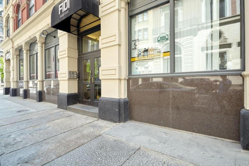 a store front of a building on a street at Airy 2BR in Fidi Boston Walk anywhere in Boston