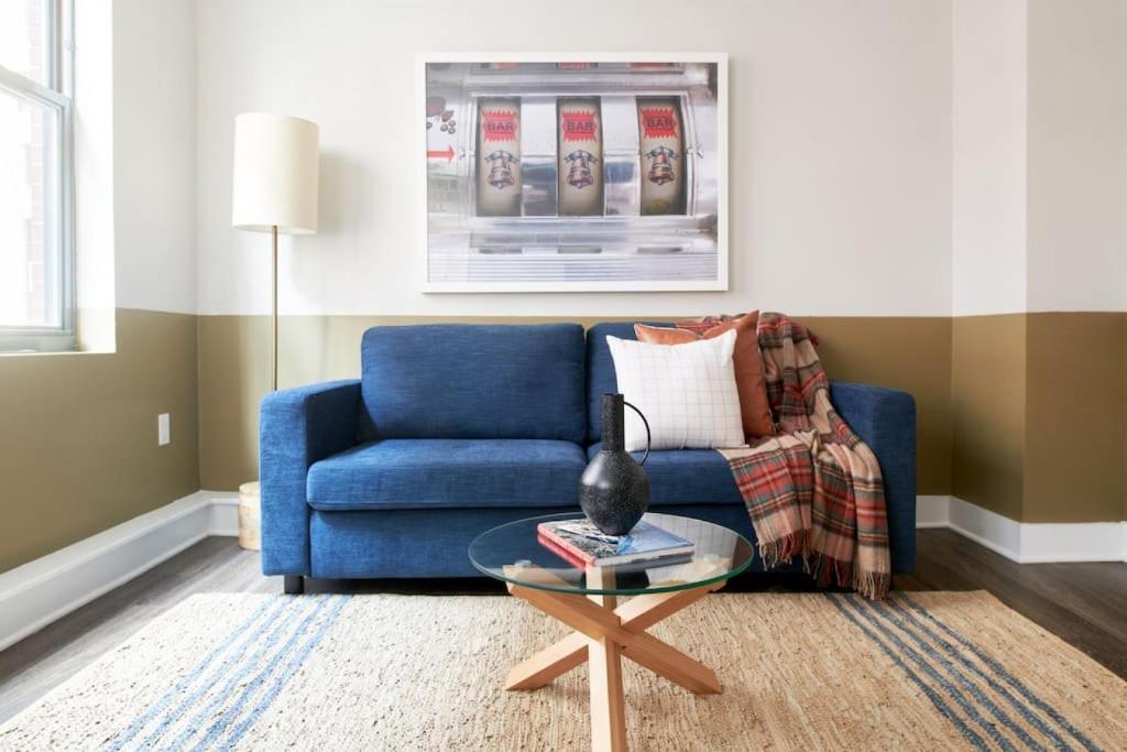 a living room with a blue couch and a table at Spacious 1br In Boston FIDI Close to T in Boston