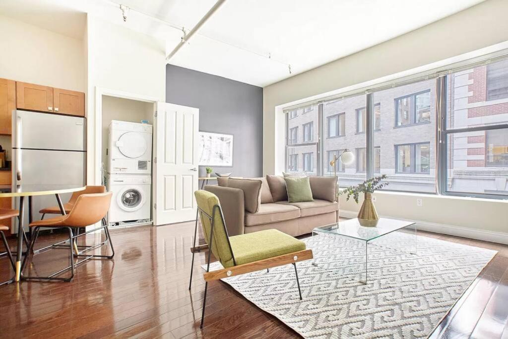 a living room with a couch and a table at 2br 2ba FIDI Apt Keyless Entry Walk anywhere in Boston