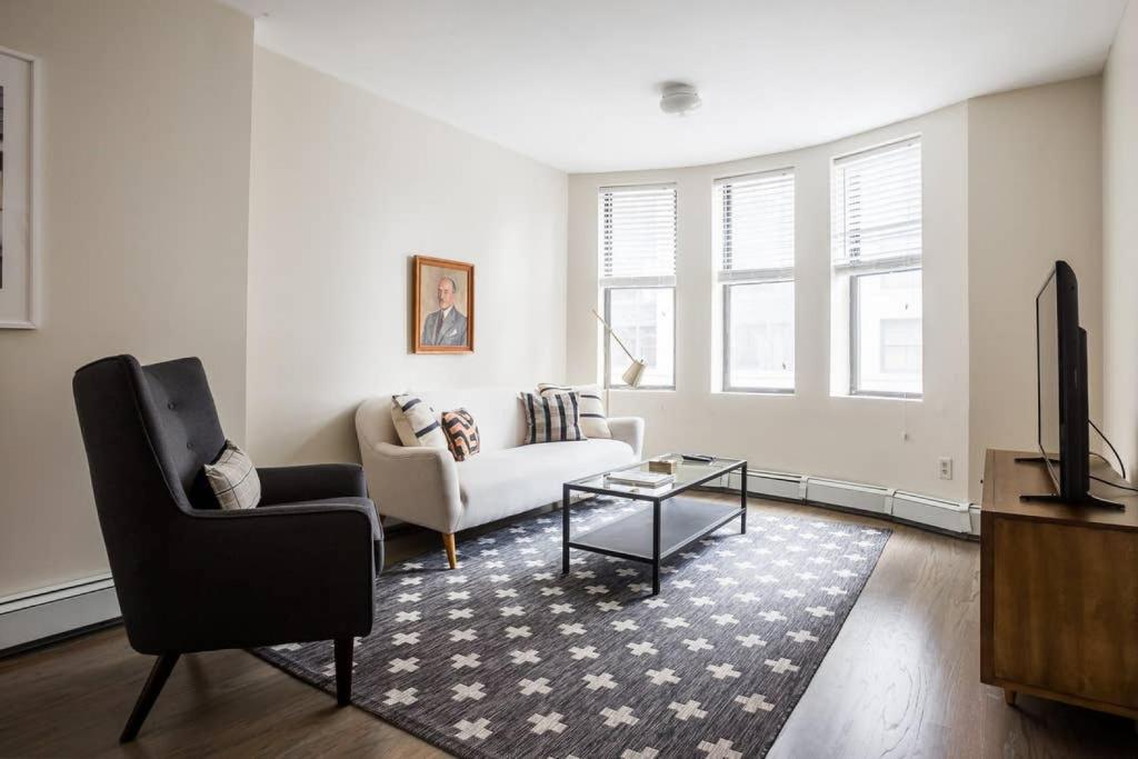 a living room with a couch and a table at Beautiful 2 Bedroom Financial District Apartment in Boston
